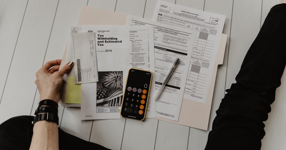 Tax forms and calculator on a desk